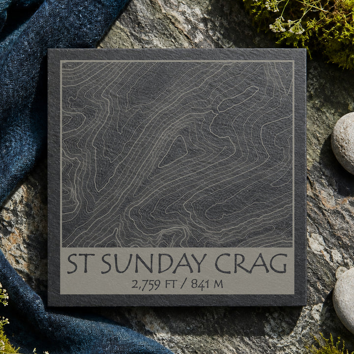 St Sunday Crag topographic slate coaster on grey rock with moss, pebbles and heather