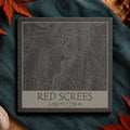 Red Screes topographic slate coaster on pale stone with autumn leaves and map details
